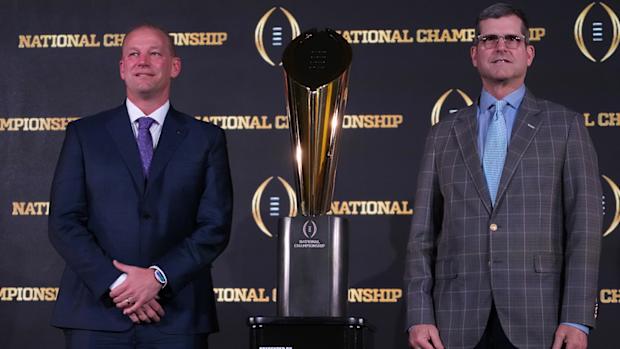 Washington’s Kalen DeBoer, Michigan’s Jim Harbaugh pose in front of 2024 College Football Playoff trophy.